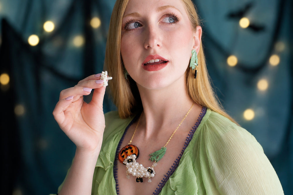 Zombie hand popcorn necklace detail — articulated acrylic horror jewelry — LaliBlue Midnight Cinema