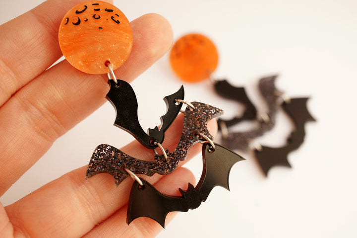 Halloween moon and bats earrings worn — spooky celestial acrylic jewelry — LaliBlue Midnight Cinema