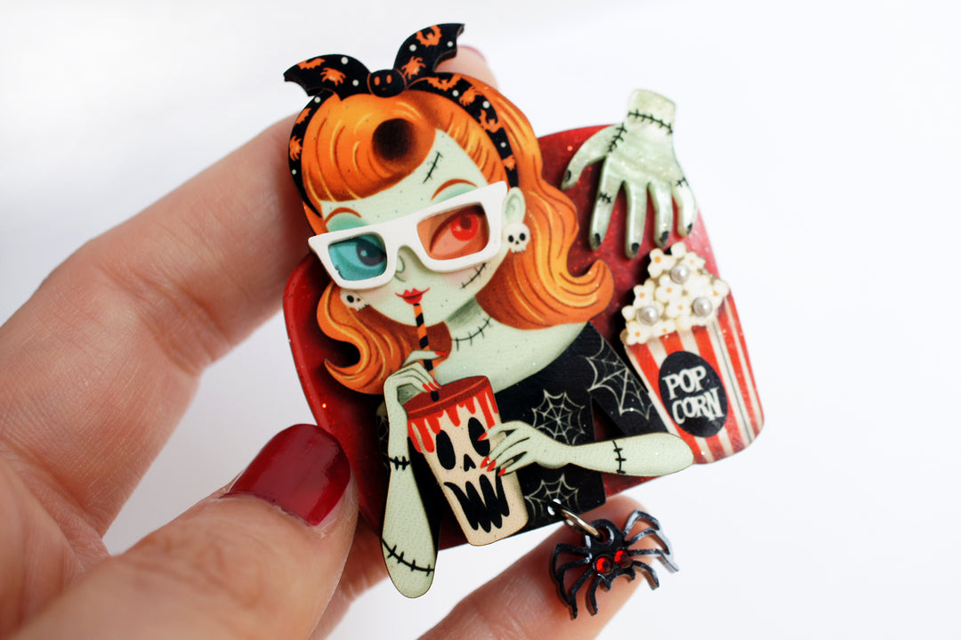 Zombie girl brooch worn — cinema viewer with popcorn and spider — Halloween acrylic glitter jewelry — LaliBlue Midnight Cinema