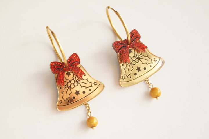 Gold bell earring close up with red bow, LaliBlue Christmas jewelry, mirror acrylic