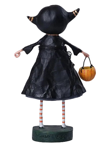 Halloween-themed figurine with black dress, striped legs, and pumpkin basket on a gray background