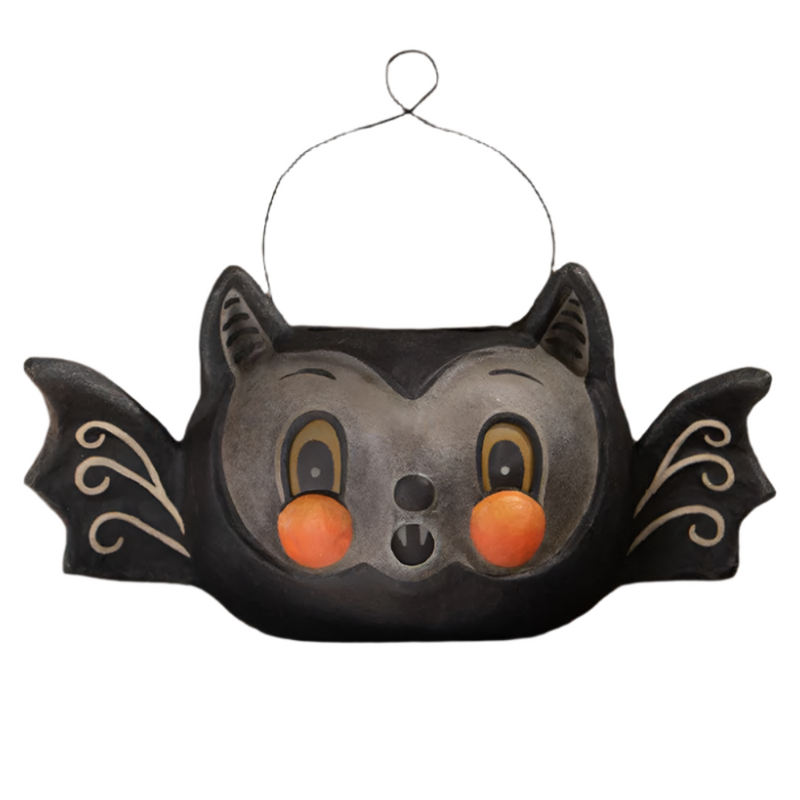 A decorative paper mache bucket with a bat shape, featuring cut-out eyes and a mouth, in a black color with orange details. johanna parker batty barnum bucket