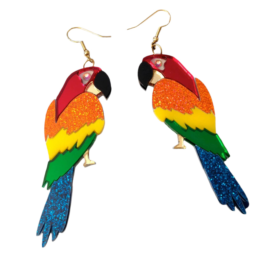 Colorful parrot-shaped earrings on a black and white striped background with heart patterns.
