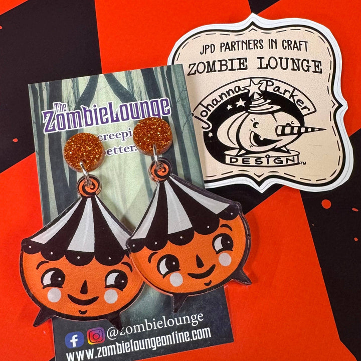 Zombie Lounge earrings on a checkered background with brand logo.