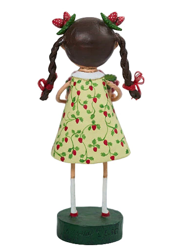 Doll with a yellow dress featuring red strawberries on a white background