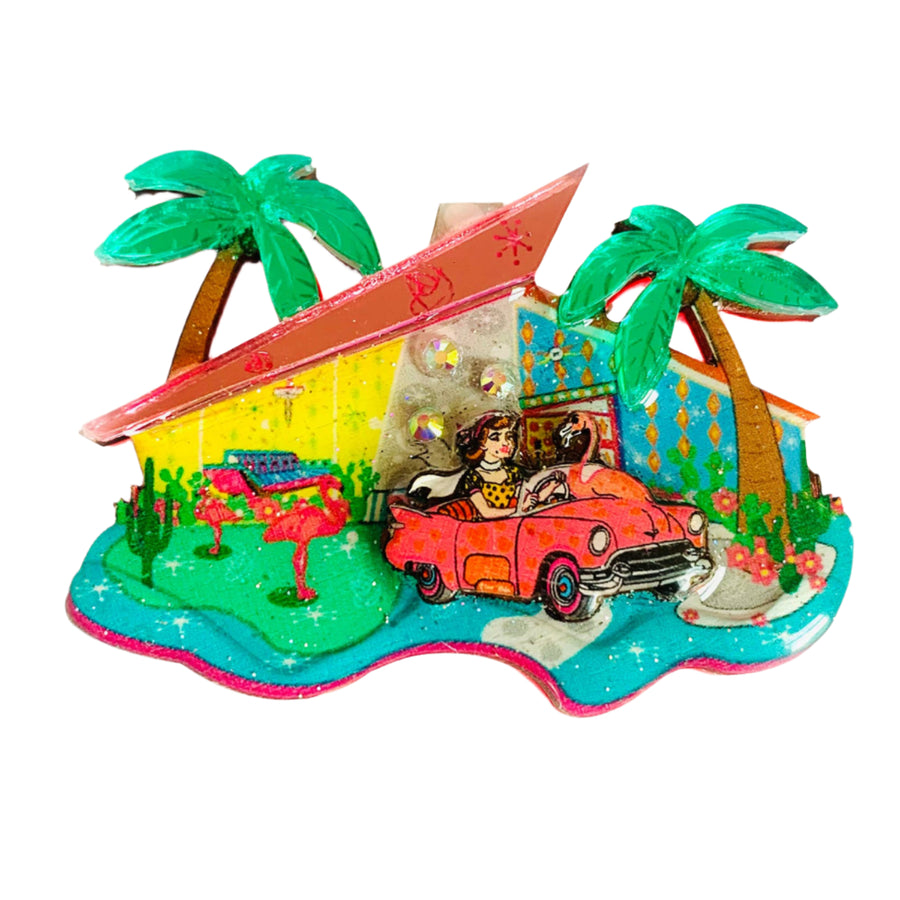 Colorful mid century palm springs house with palm trees, and a vintage car 