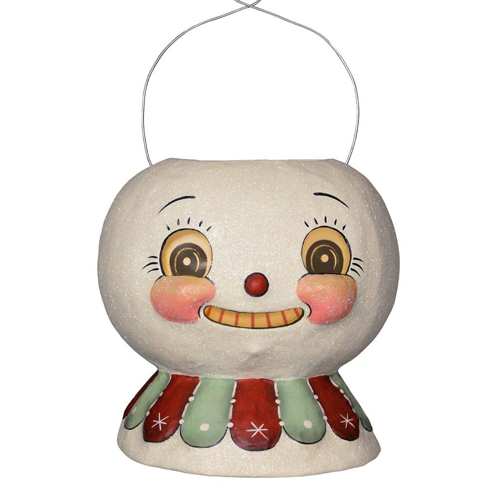 A decorative snow glow lantern bucket with a whimsical face design, primarily in white with red and green accents. johanna parker bethany lowe