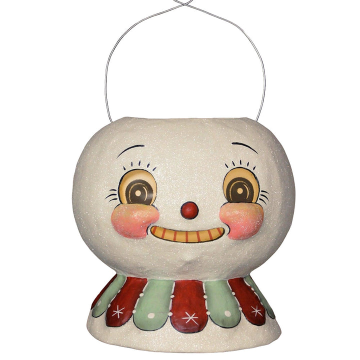 A decorative snow glow lantern bucket with a whimsical face design, primarily in white with red and green accents. johanna parker bethany lowe