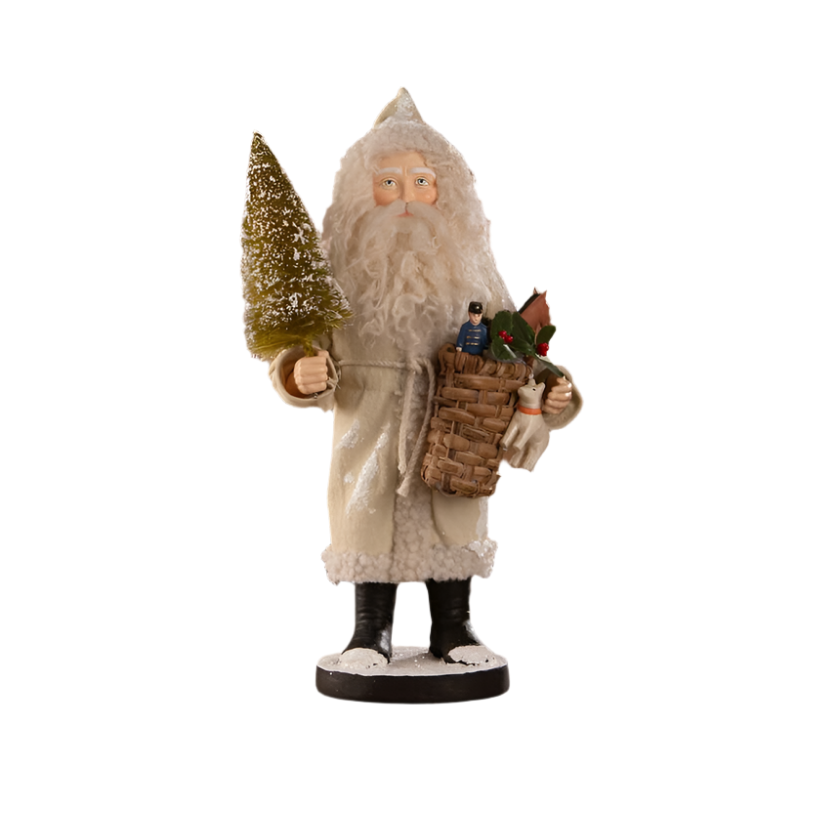 A small figurine of Santa Claus with a toy basket and a miniature Christmas tree, dressed in a rustic tan coat, part of the Bethany Lowe Designs collection.