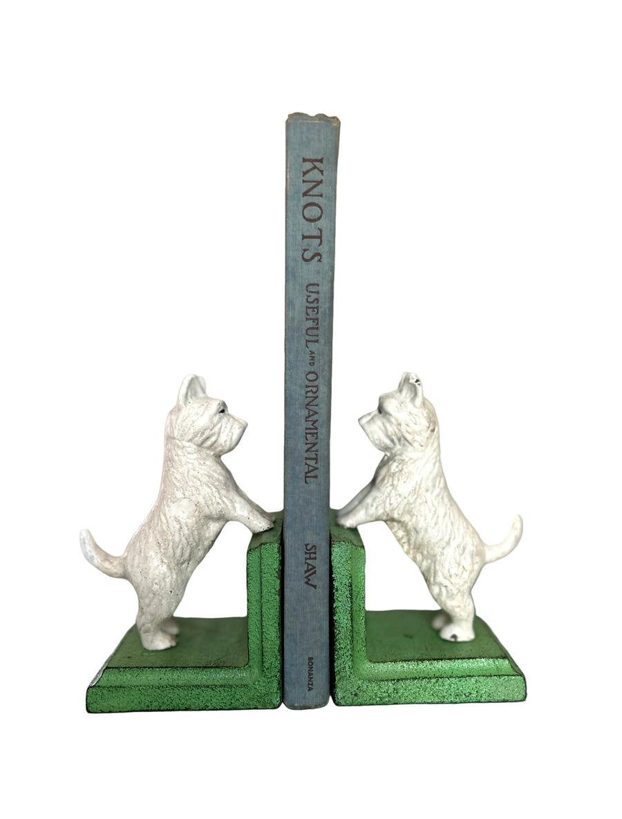 Cast iron Westie bookends holding a book