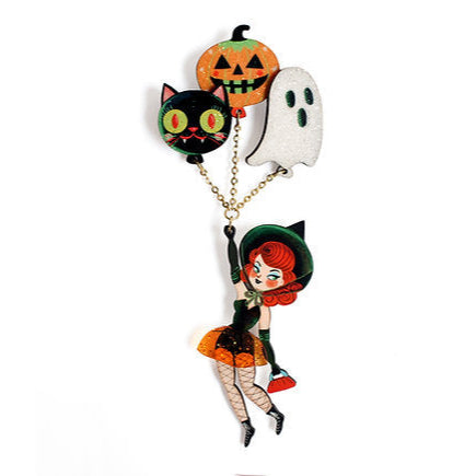 This witch has traded her broom for helium balloons!


 Each balloon is attached to the witch by metal chains, creating a floating effect that makes her appear to be in full flight.


 -This brooch is presented in two joined pieces :
— The top part (the balloons) is attached with a traditional safety pin .
— The lower part (the witch) is attached to the clothing with a safety pin , preventing it from turning and ensuring that it always stays properly positioned and hangs gracefully.


 -Made of illustrated 